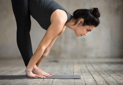 young woman ardha uttanasana pose 1