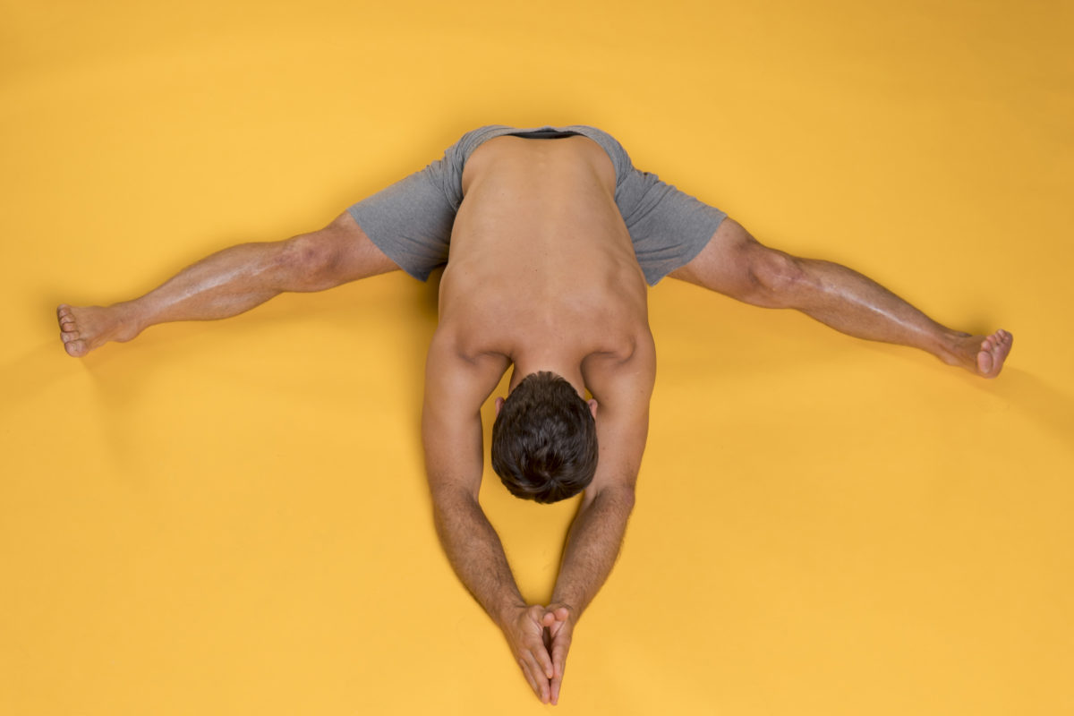 top view man seated forward bend pose